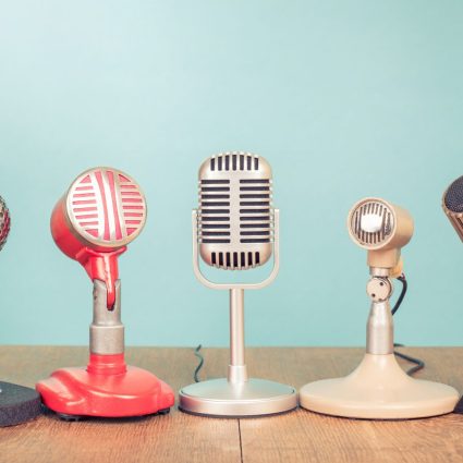 Collection of microphones on wooden table